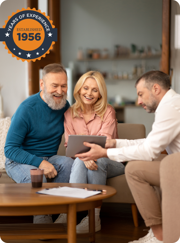 Woman managing downsizing services while speaking on the phone and working on a laptop - Gordon's Downsizing